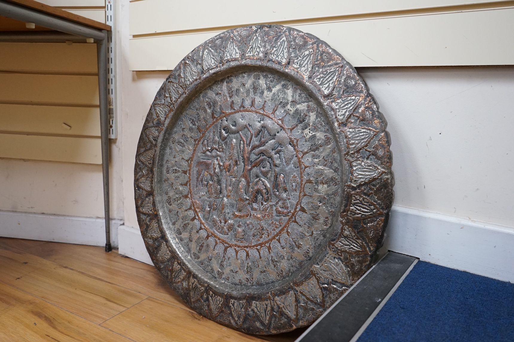 A circular Persian tinned copper embossed tray 88cm diameter